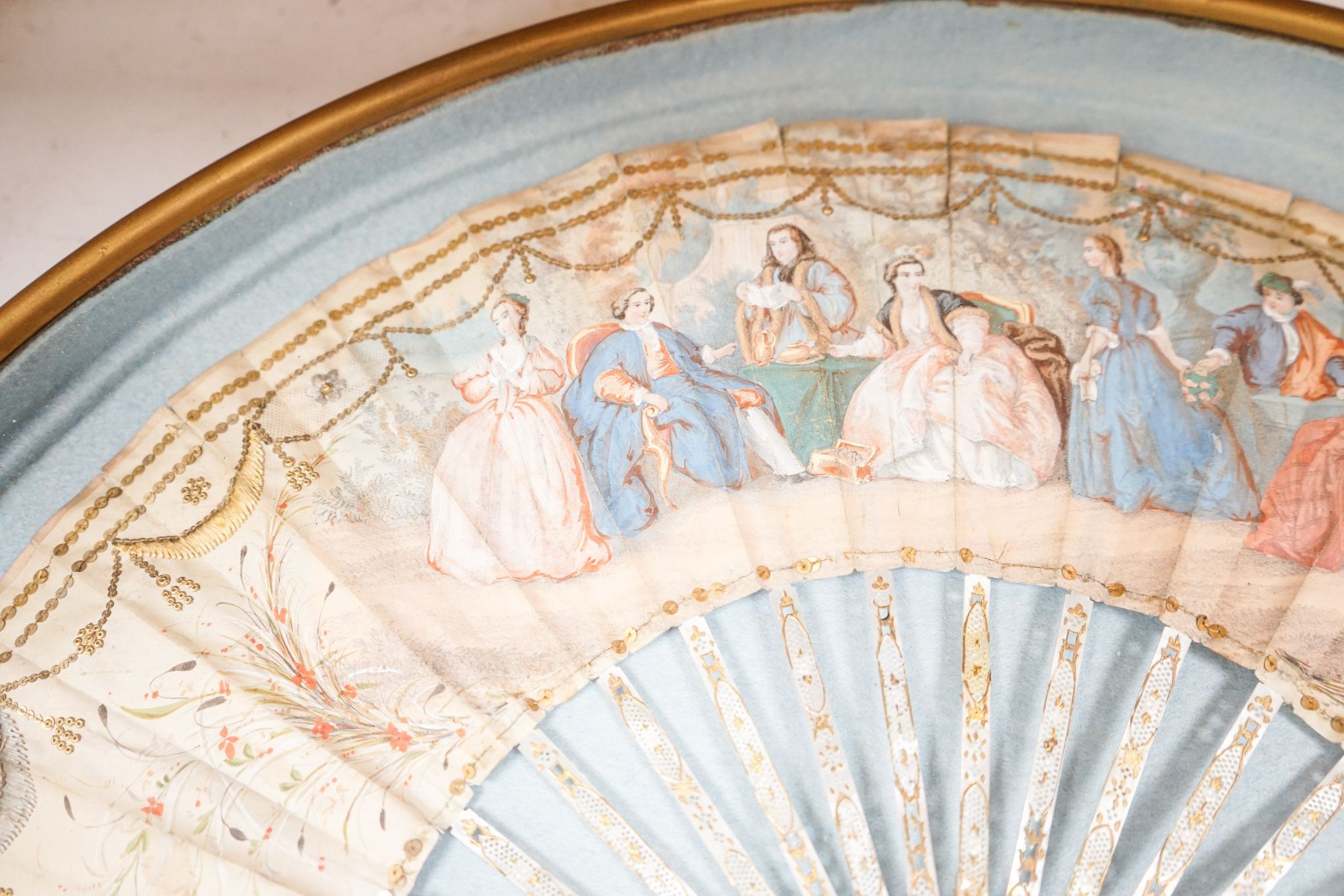 A late 18th / early 19th century Continental figurative framed fan and two religious cased effigy of baby Jesus